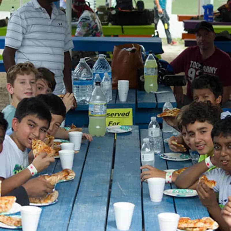 Kids eating cake and pizza at a table