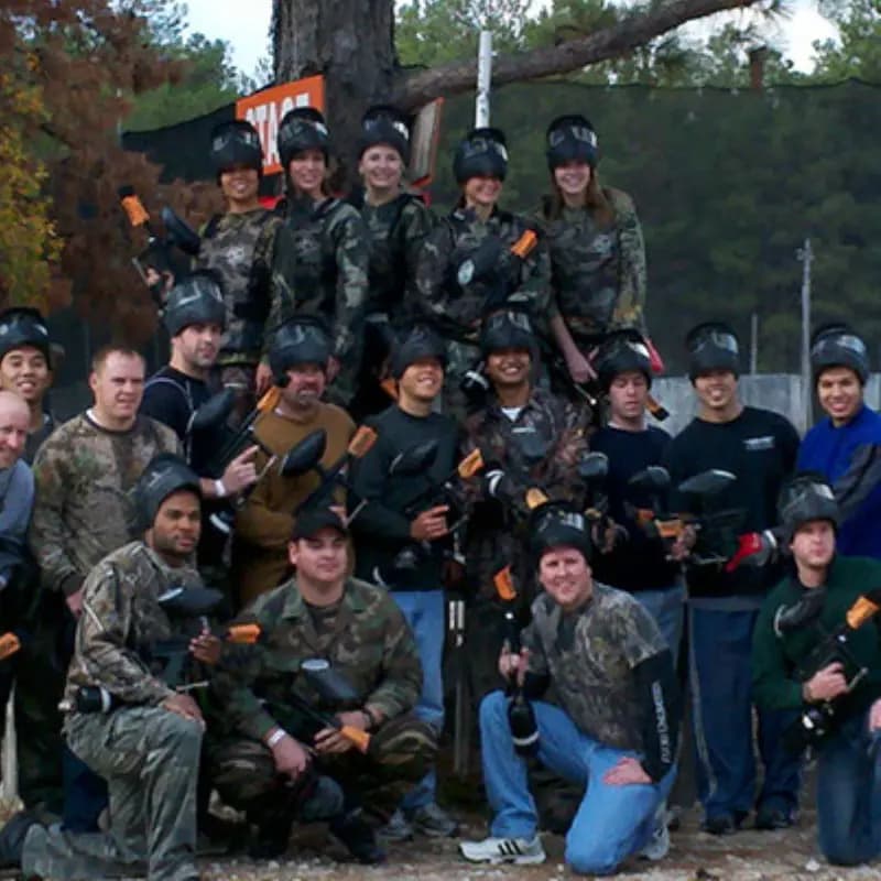 Men and women wearing paintball gear
